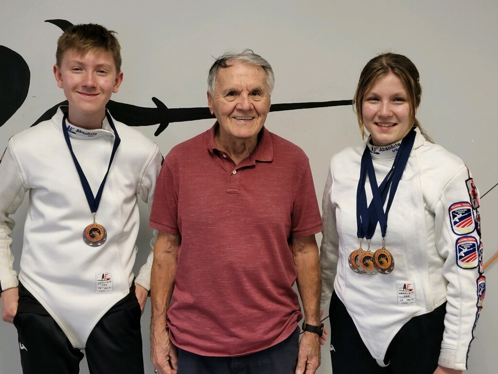 Gabriel Marisi and Gianna Marisi proudly displaying their 4 medals from the Bull City Fencing Tournament, photographed inside Salle D'Armes Bosco fencing center in Madison, Alabama
